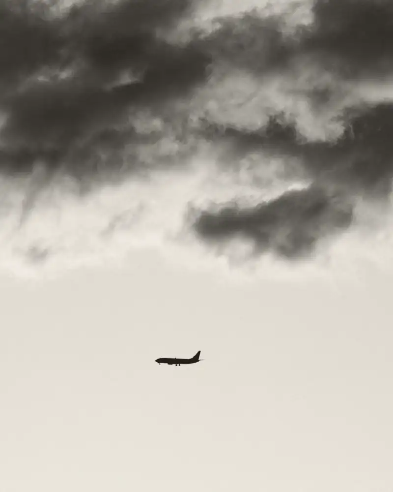 An aircraft under a heavy evening sky.